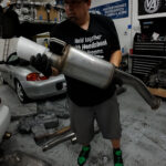 Aaron holds the rear section of a 3 inch Thermal Research and Development exhaust for a FA5 Civic Si sedan.