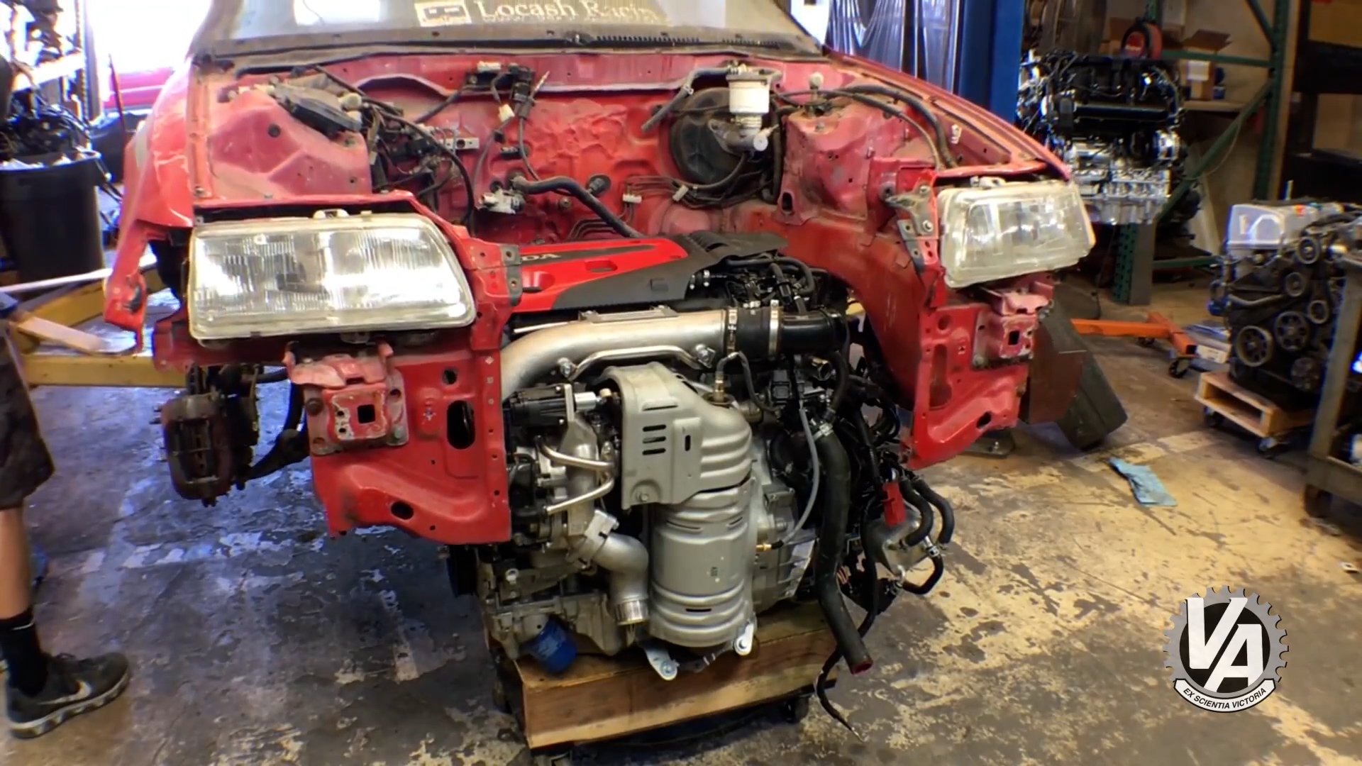 K20C1 engine and transmission on a rolling cart with a red Honda CR-X being lowered around it.